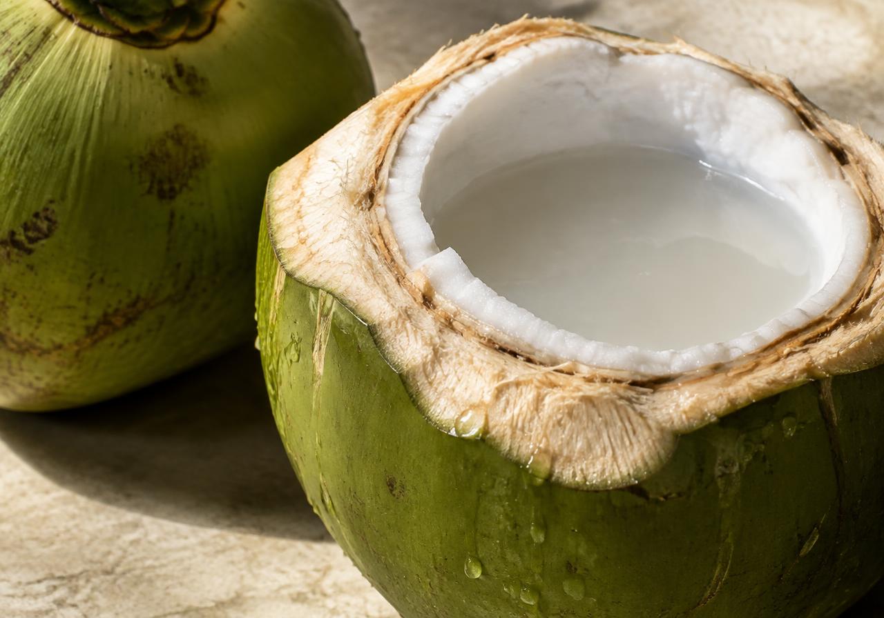 Fresh tender coconut cut open to reveal its flesh and water